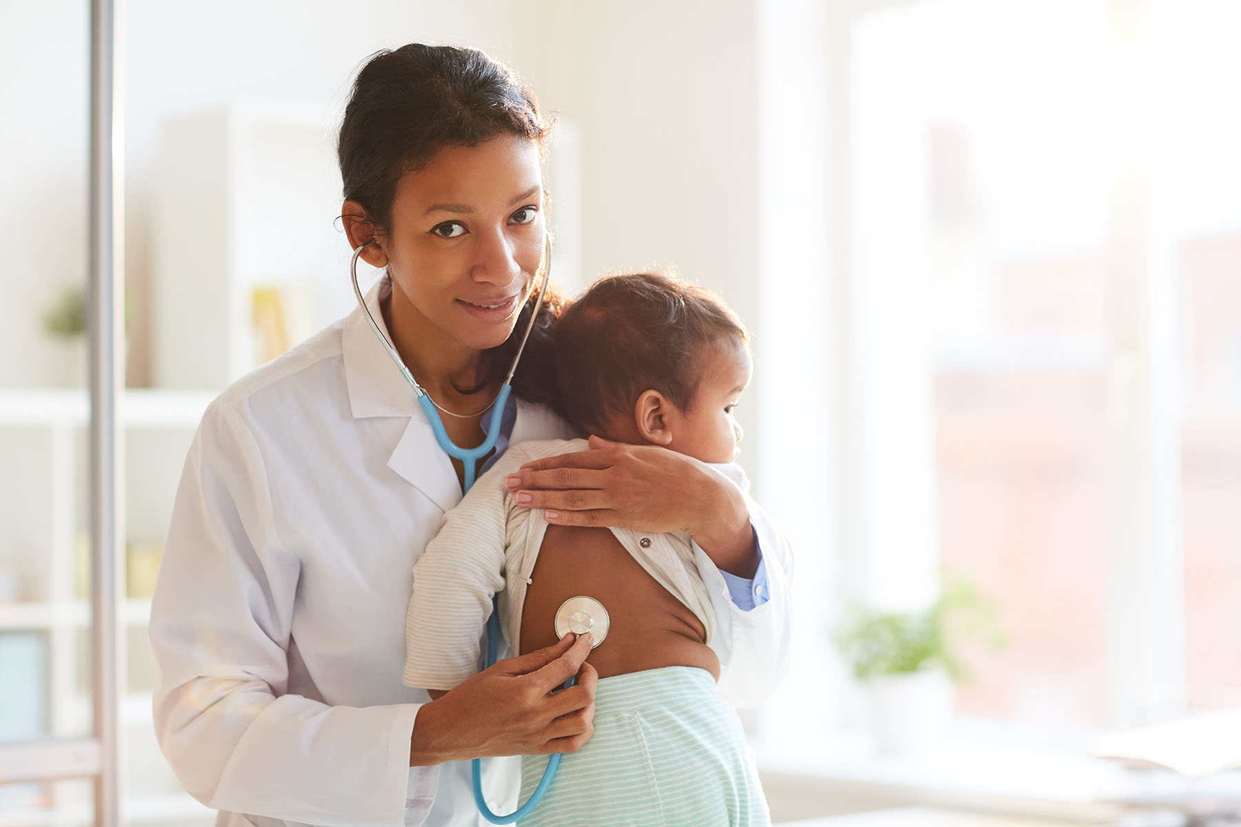 Image showing nurse holding a baby.