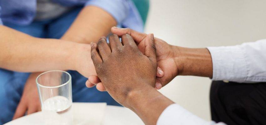 Social worker holding hands of another person