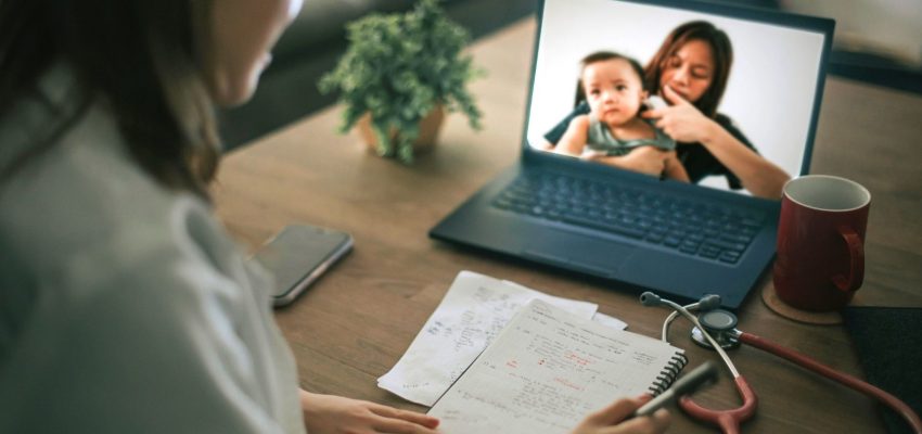 Medial provider watching screen with mother and infant patient